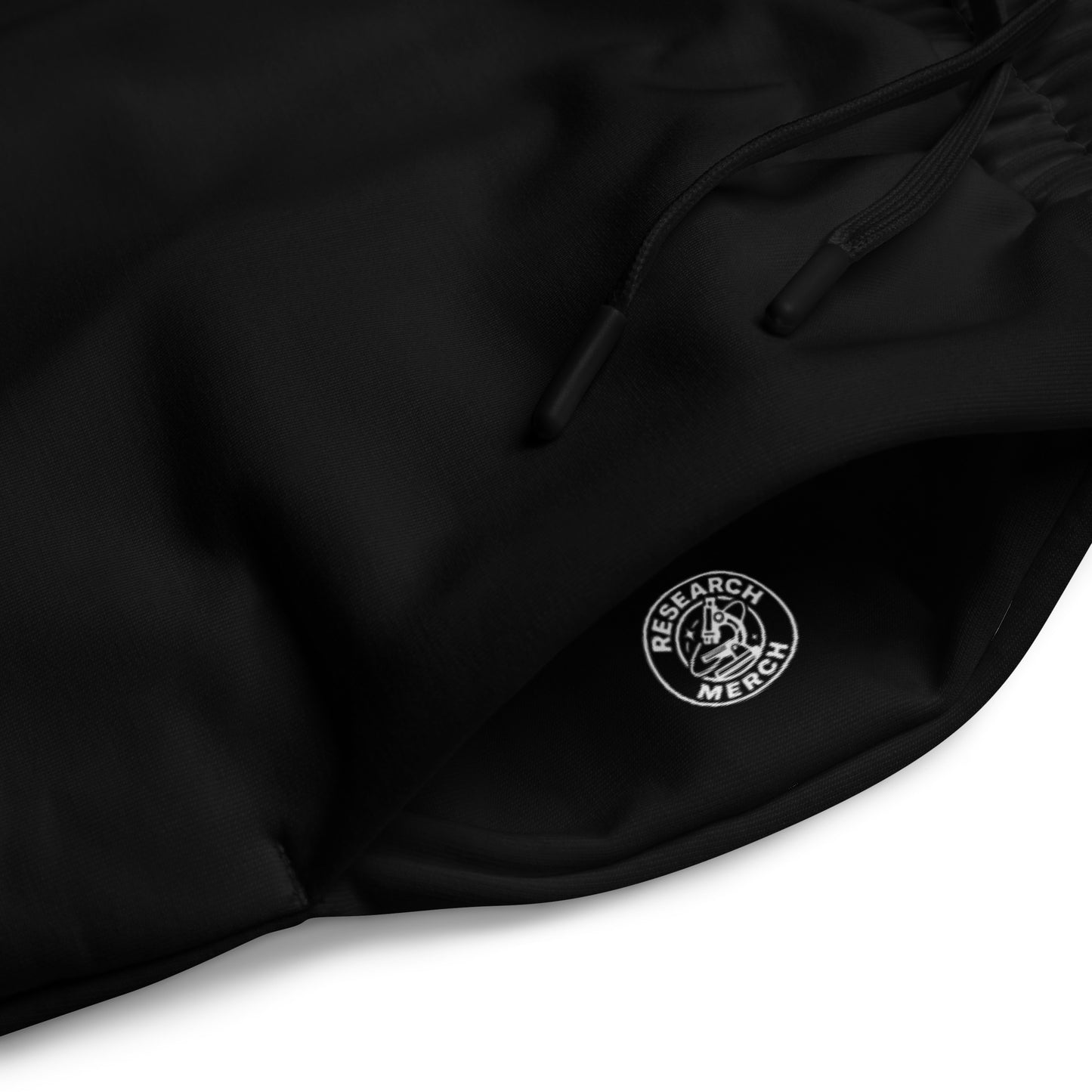 Research Merch Unisex Wide Leg Jogger aus der Purpose Collection in der Detailansicht mit Logo in der Hosentasche